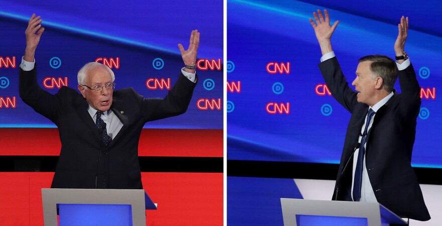 Democratic presidential candidate Sen. Bernie Sanders (left) gestures while former Colorado governor John Hickenlooper (right) speaks during the Democratic Presidential Debate at the Fox Theatre in Detroit, Michigan.