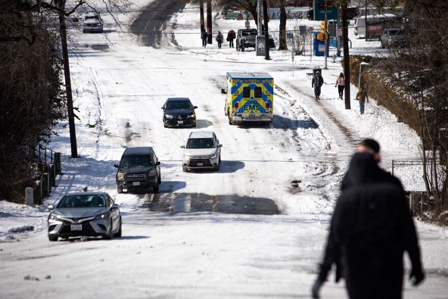 An ambulance drives on Oltorf Street in the Travis Heights neighborhood of south Austin during a winter storm on Feb. 16, 2021.