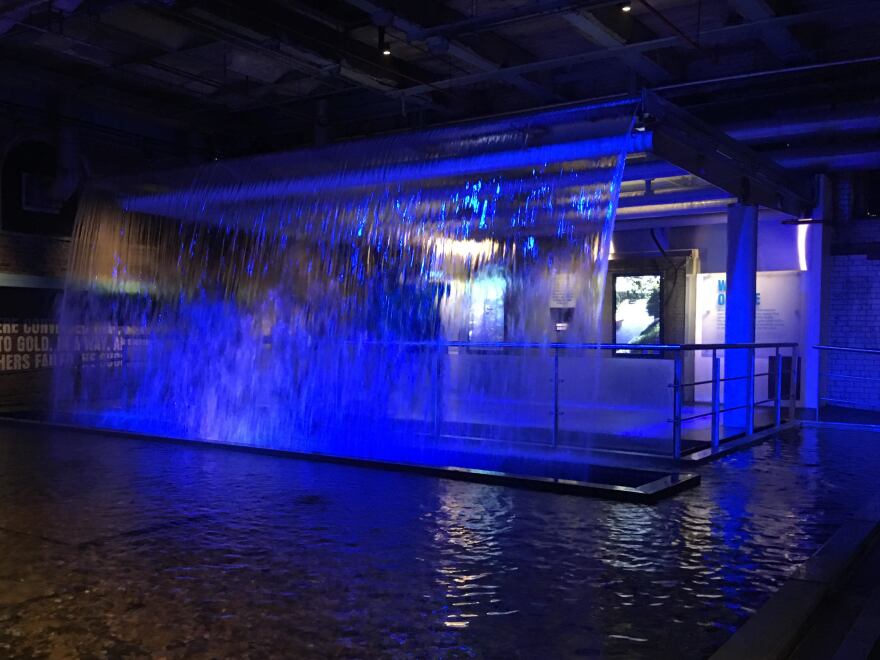 A waterfall bathed in blue light greets visitors at the Guiness Storehouse in Dublin — a symbol of the water from the nearby Wicklow Mountains that Guinness uses to brew its stout.