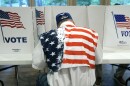 FILE - A patriotic voter sits at a voting kiosk and selects his choices in a party primary in Jackson, Miss., Tuesday, Aug. 8, 2023. Super Tuesday put former President Donald Trump within reach of clinching his third consecutive Republican presidential nomination. But it may be Republican voters in Georgia, Hawaii, Mississippi and Washington who put him over the top. President Joe Biden is also competing in presidential contests that day, but the earliest he can clinch his party's nomination is a week later on March 19. (AP Photo/Rogelio V. Solis, File)
