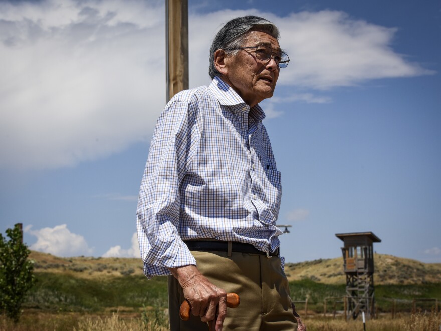 Former Commerce Secretary Norman Mineta walks past a guard tower at the site of a former prison camp near Heart Mountain, Wyo., where he and his family were wrongfully incarcerated during World War II.