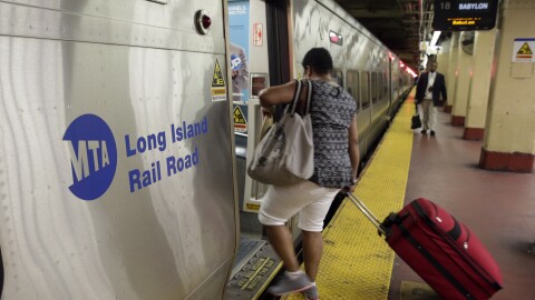 Passengers board a Long Island Rail Road train, in New York's Penn Station.