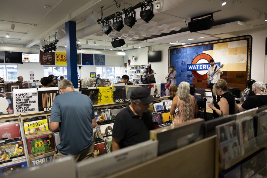 People shop as Cast Iron Shoes performs at Waterloo Records.