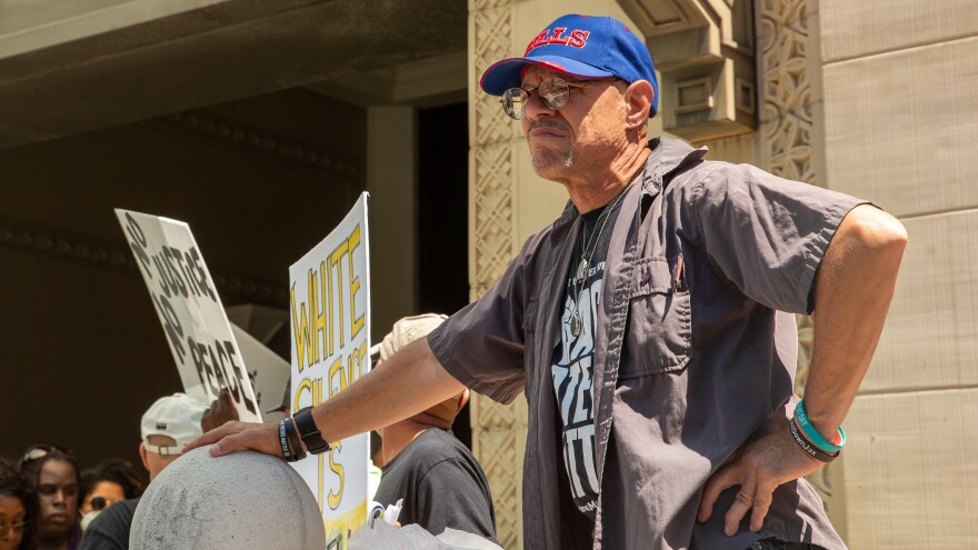 Tom McGuire was among the nearly two dozen people who attended a unity protest on the steps of City Hall on Monday, May 16, 2022.