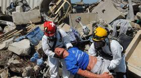 Rescue workers pull a simulated victim from the rubble at the Muscatatuck Urban Training Center during an exercise in July 2012.