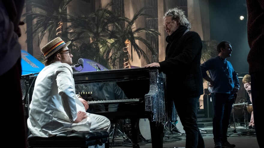 Taron Egerton as Elton John (right) and Dexter Fletcher on the set of <em>Rocketman</em>