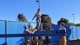 Cadet Meg Harris walks a balance beam while teammates Preston Barker (left) and Morgan Simis follow along at the Dixie High School obstacle course.