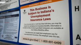 A public notice inside a human resources office stating it is subject to Indiana's unemployment insurance laws.