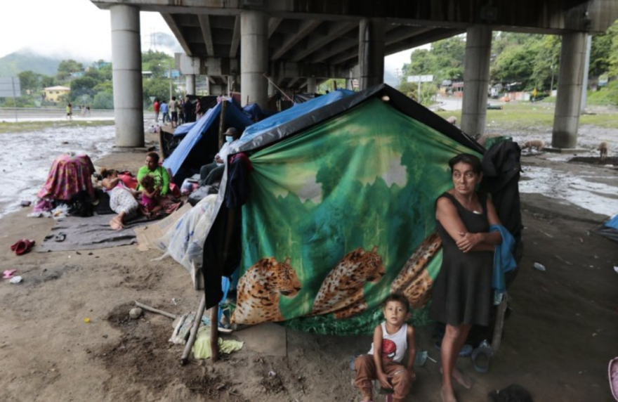 Hondurans left homeless by Hurricanes Eta and Iota last November living in tents on the only patch of dry ground they can find, under a highway in the northern city of San Pedro Sula.