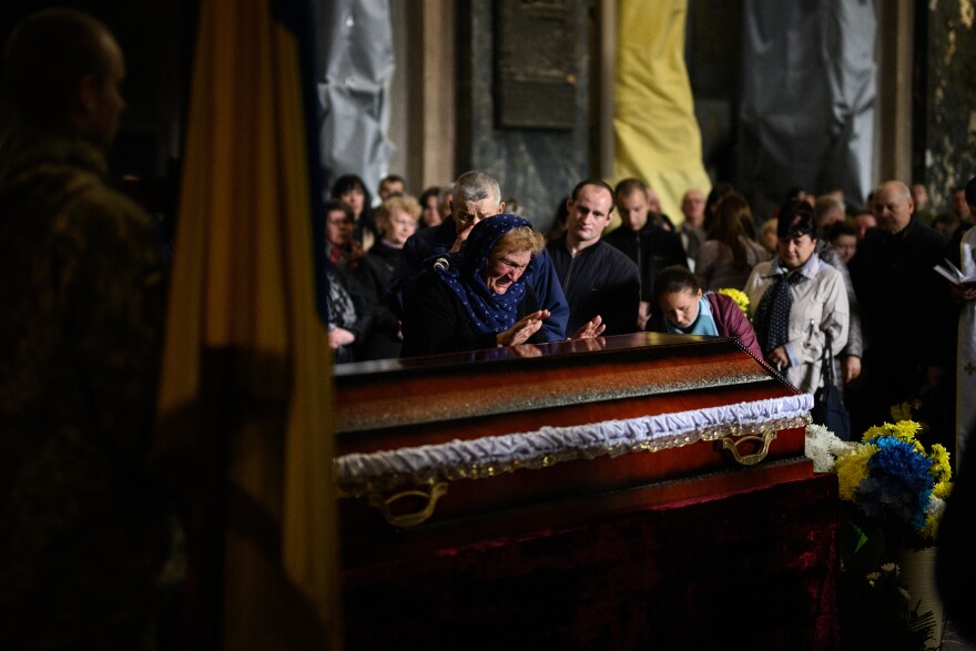 <strong>April 29:</strong> Mourners grieve during the funeral service of fallen soldier Lubomyr Tazaev, aged 36, at the Saint's Peter and Paul Garrison Church in Lviv, Ukraine. Lviv has served as a stopover and shelter for the millions of Ukrainians fleeing the Russian invasion, either to the safety of nearby countries or the relative security of western Ukraine.