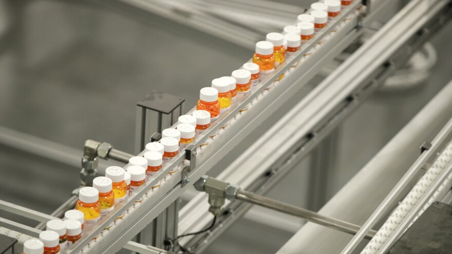 Bottles of medicine ride on a belt at the Express Scripts mail-in pharmacy warehouse in Florence, N.J., in 2018. Democratic lawmakers have reached a deal to lower prescription drug prices for seniors.