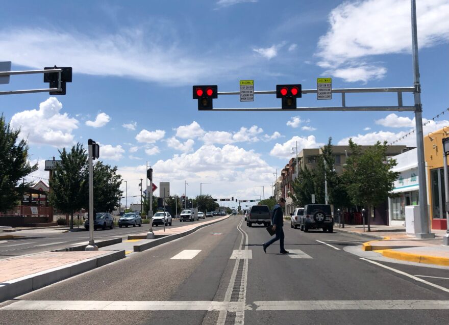 Drivers struck and killed 89 pedestrians in New Mexico in 2025, according to recent data from the University of New Mexico, which is the lowest number in five years. Above: A pedestrian crosses Central Avenue in Albuquerque with the help of a “hybrid beacon” traffic light in July 2022 (Source NM file photo)