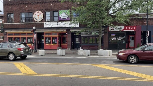 Cars drive through Highland Square's nightlife district on June 11, 2026. All bars will voluntarily close early this weekend to try to curb safety issues except Highland Tavern.