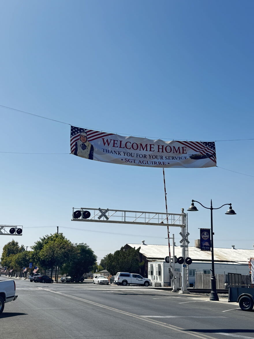 Banner that says "Welcome home. Thank you for your service Sgt. Aguirre."