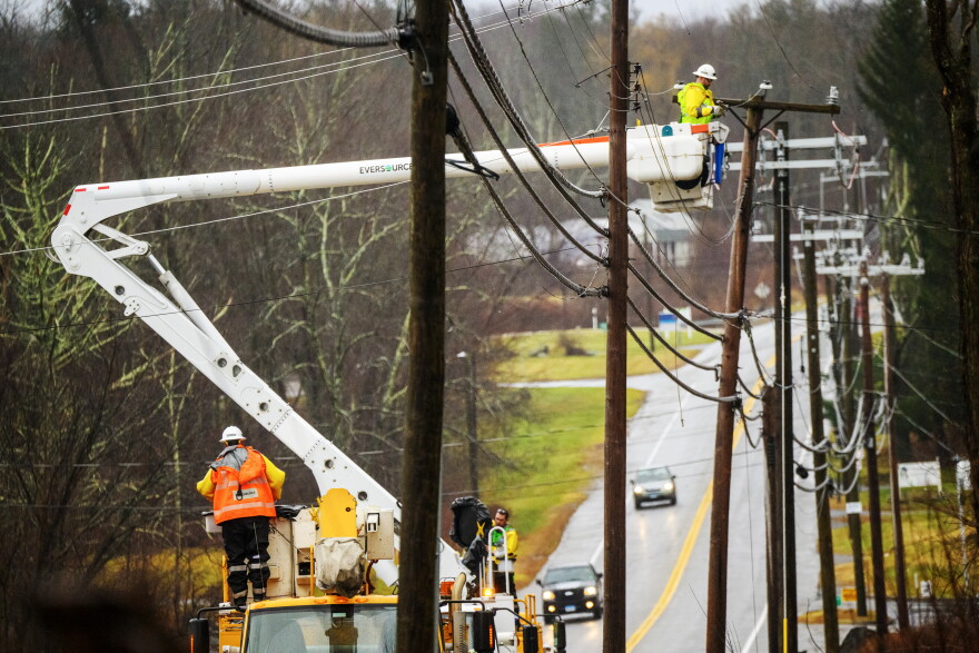 FILE: An Eversource crew on Route 44 in Bolton, Ct. repairs damaged power lines, December 18, 2023, as strong winds and heavy rain across Connecticut left more that 75,000 people without power, closed schools and snarled traffic.