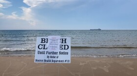 A sign warning of diesel fuel in the water sits