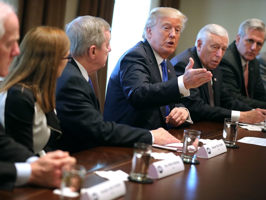President Trump presides over a meeting about immigration with Republican and Democratic members of Congress at the White House on Tuesday. Congress and the White House are trying to work out an immigration deal prior to Jan. 19.