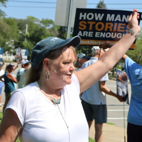 Bonnie Zampino waves to onlookers at a rally in Orleans to support former and current residents of the Community of Jesus. Zampino, who says she lived at the religious commune as a teen, tells CAI and the Provincetown Independent she was sexually abused by the group's doctor.