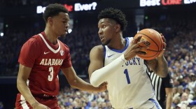 Kentucky's Justin Edwards (1) looks for an opening against Alabama's Rylan Griffen (3) during the first half of an NCAA college basketball game Saturday, Feb. 24, 2024, in Lexington, Ky. (AP Photo/James Crisp)