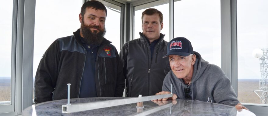 From left to right, Joe Polaski, John Hecker and Larry Bickel, officials from the Moshannon Forest District, gather around the alidade, an instrument used to help personnel staffing lookout towers pinpoint the location of wildfires.