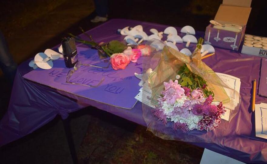 Flower, candles and signs on a table.