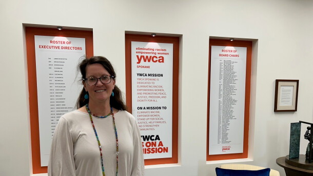 YWCA Spokane CEO Janine Wynne stands in building atrium. 