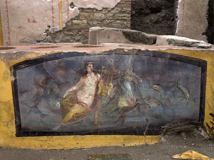 A painting of a sea nymph riding a sea horse adorns one of the counters in the thermopolium.