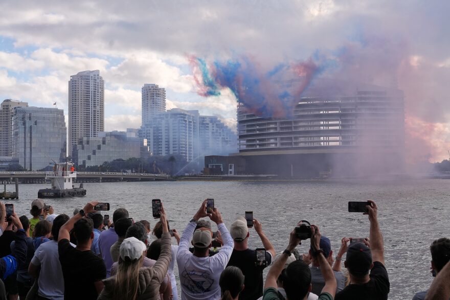 People watch pyrotechnics just before the controlled implosion of the former Mandarin Oriental Hotel on Brickell Key, Sunday, April 12, 2026, in Miami.