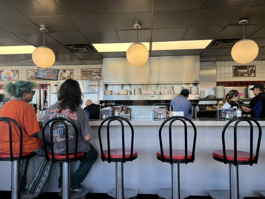 Customers wait for to-go orders at the Waffle House in Navarre after Hurricane Isaias.