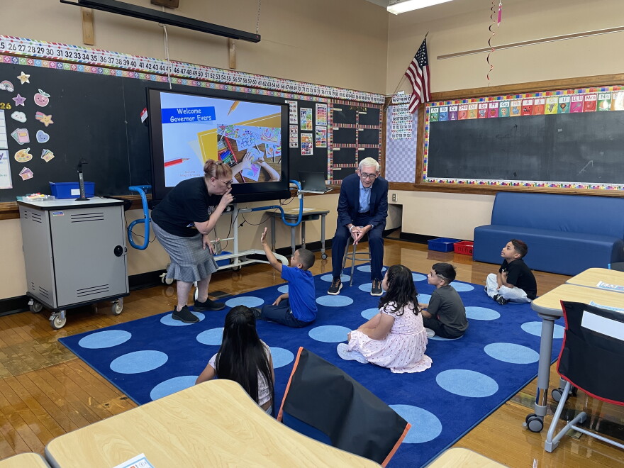 Gov. Tony Evers meets with Lincoln Avenue Elementary students in a bilingual class at Pulaski High School, where the school has relocated for the year due to a June 2026 fire.