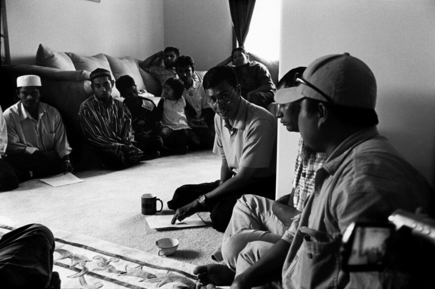 Taking the role of organiser and activist, Myo Myint addresses a meeting of Burmese Muslim refugees in his brother's house in Fort Wayne, Indiana.
