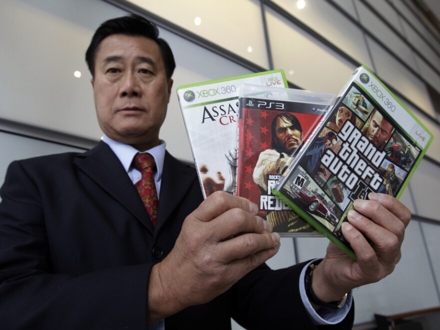 Calif. State Sen. Leland Yee, D-San Francisco, holds up three video games after a news conference in San Francisco, Monday. The Supreme Court ruled that it is unconstitutional to bar children from buying violent video games, saying government doesn't have the authority to "restrict the ideas to which children may be exposed" despite complaints.