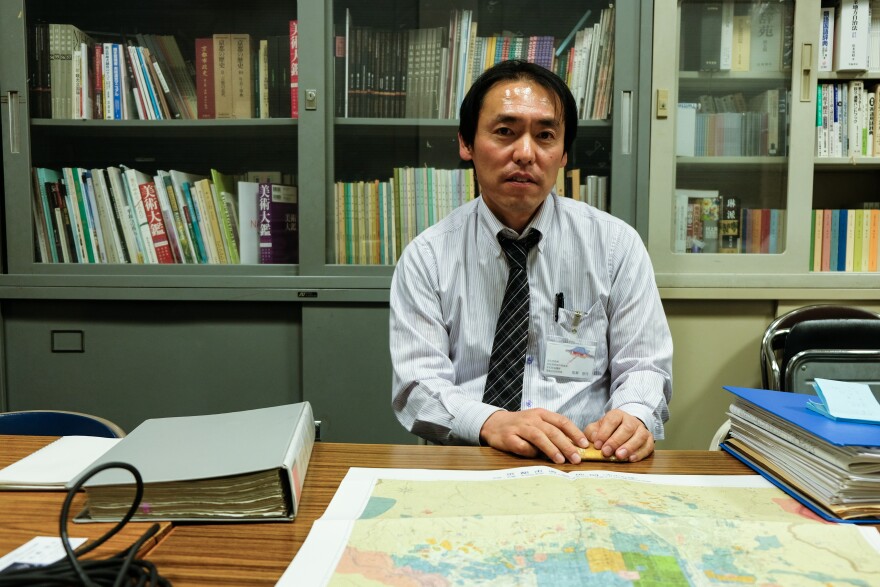 Archaeologist Tomomitu Umase, who runs the Kyoto city government office in charge of archaeology, displays a map of historical sites around the former imperial capital. He estimates that only 1 percent of the relics uncovered by a pre-Olympic building boom are being preserved.