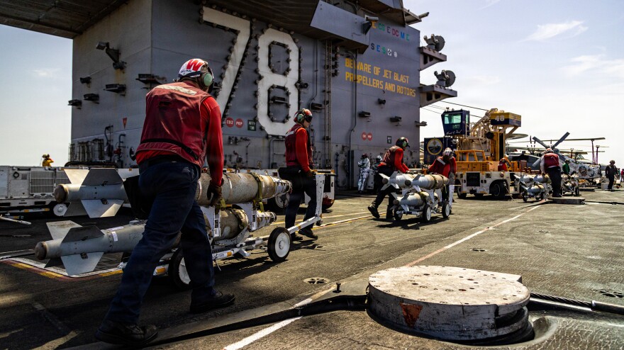U.S. Sailors transport ordnance across the flight deck of the USS Gerald R. Ford (CVN 78), while underway.