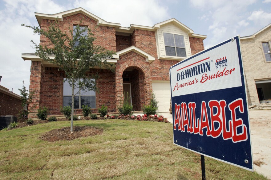 A red brick house stands with a sign that says "AVAILABLE" out front.