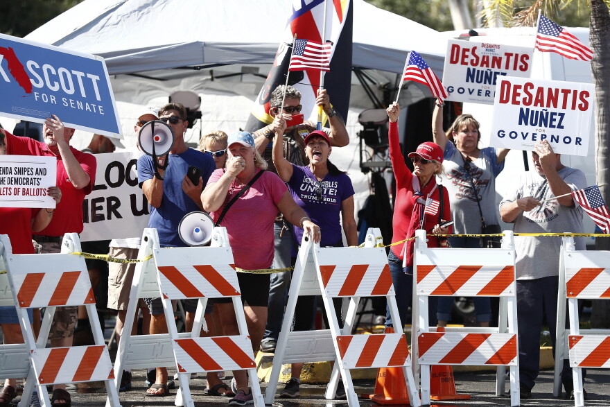 Protesters gather outside of the Broward County Supervisor of Elections office during a recount on Sunday, Nov. 11, 2018, in Lauderhill, Fla. 