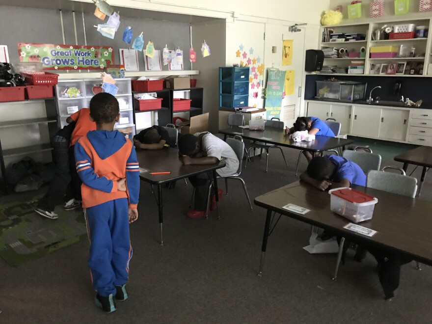 Harrington students play the classic elementary school game "Heads Up, Seven Up."