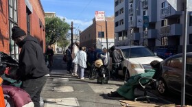 A crowd gathers around Nurse Albert in the Mission District on March 23, 2026