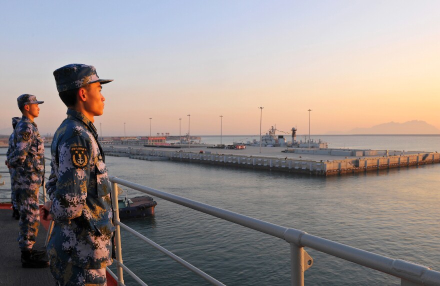 Chinese naval soldiers stand guard on China's first aircraft carrier, Liaoning, as it travels toward a military base in Hainan province, in this undated picture made available on Nov. 30, 2013. Tensions in the South China Sea have grown over territorial disputes between China, the Philippines, Japan and others.