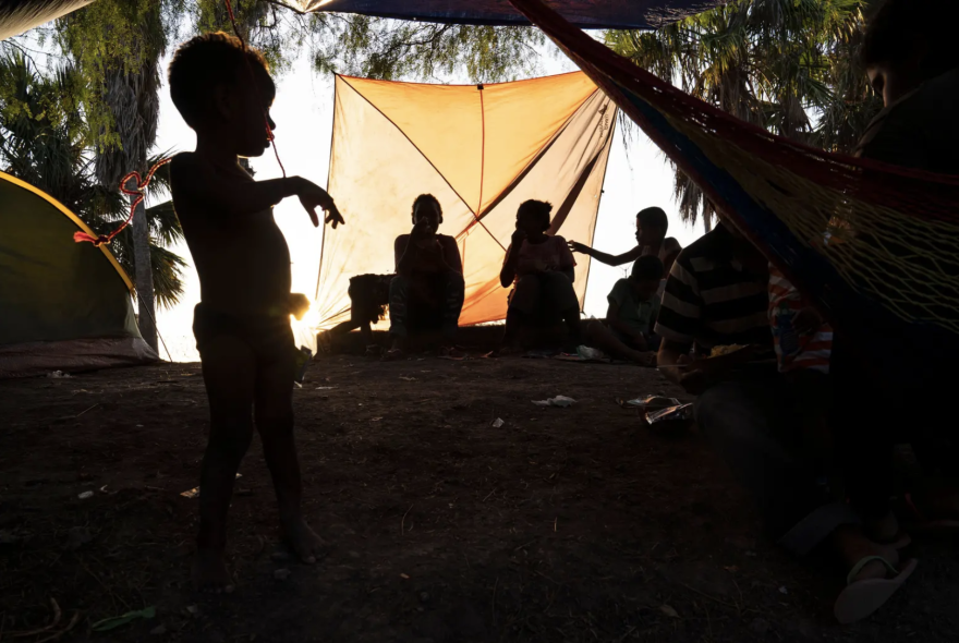 A group of migrants pass time in an encampment in Matamoros, Tamaulipas, as they wait their turn to seek asylum in the U.S. in 2019. 