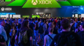 A photo shows visitors in front of the Xbox booth at the Gamescom video game fair in Cologne, western Germany.