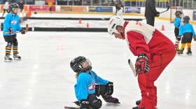 Palmer Zaleski looks up to listen to volunteer Paul Eyerman during a Girls Try Hockey event at the Toyota SportsPlex in Wilkes-Barre.