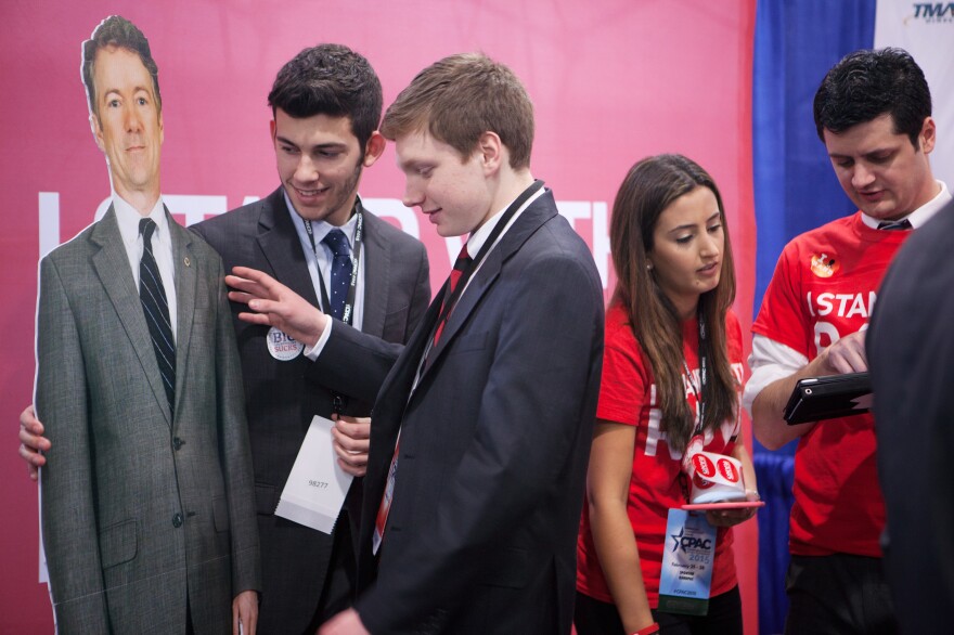 Josh DiNatale (left) and Zachary Burns, St. Joseph's University students and members of their College Republicans chapter, get ready to pose for a photo with a cutout of Sen. Rand Paul at CPAC 2015.