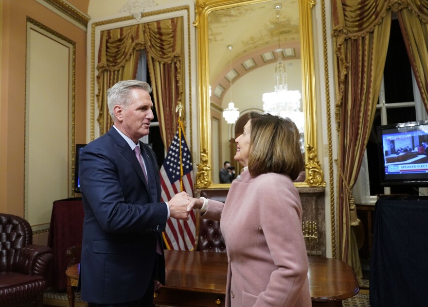 Rep. Kevin McCarthy (R-CA) shakes hands with former House speaker Nancy Pelosi (D-CA).