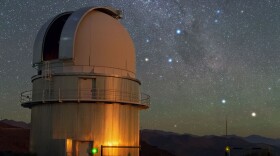 In the sky above ESO's La Silla Observatory, the Southern Cross is visible to the right of the dome of a Danish 1.54-metre telescope. To the lower right of the image, two stars sparkle in the dark sky. From right to left, these are Alpha and Beta Centauri. Alpha Centauri is a multiple star, the nearest star system to Earth. A little closer to Earth than the bright components of Alpha Centauri, and invisible to the naked eye, is Proxima Centauri, the third star belonging to this multiple star system. (European Southern Observatory/Flickr)
