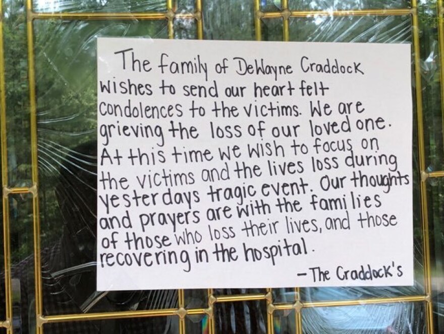 A note attached to the door of the home of one of the shooter's family members extends condolences to the victims of the Virginia Beach shooting.