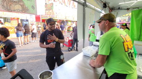 Jim Hasbrouck takes a customer's order at the Fried Specialties booth.