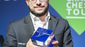 Maxime Vachier-Lagrave holding his trophy after he won the Paris Rapid and Blitz Tournament in 2019.