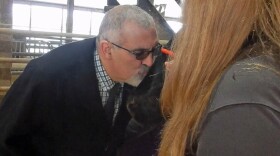 Plattsburgh Mayor Wendell Hughes kisses Miss Jackie the cow to help support the United Way of the Adirondack Region