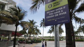 A sign asks people not to visit Miami Beach if they have a cough or fever, Monday, June 22, 2020. (Wilfredo Lee/AP)